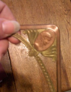 close-up of embossing on antique copper bookmark